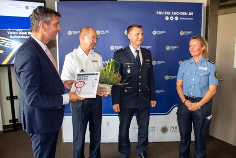 <p>Anerkennung f&uuml;r besonderes Engagement: Landrat Henry Graichen &uuml;berreichte die Urkunde an Vertreterinnen und Vertreter der Polizei. Im Bild von links: Frank Winkler, Revierleiter in Borna, Alexander Beitz, Leiter des F&uuml;hrungsstabs und Susan Danz, B&uuml;rgerpolizistin (v.l.n.r.).</p>
