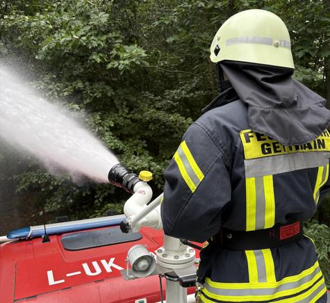 <p>Von einem Einsatzfahrzeug aus trainiert ein Feuerwehrmann die gezielte Brandbek&auml;mpfung.</p>
